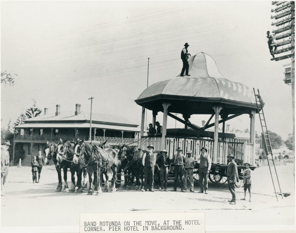 Band rotunda on the move, at the hotel corner. Pier Hotel in background 