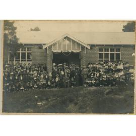 Large group of people in front of brick building 